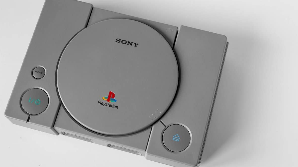 Top view of a vintage PlayStation 1 console on a clean white surface, highlighting its design.