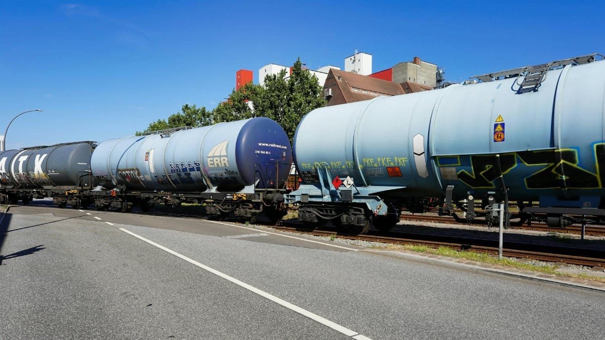 Freight train passing through Hamburg port, showcasing rail transport and global commerce.
