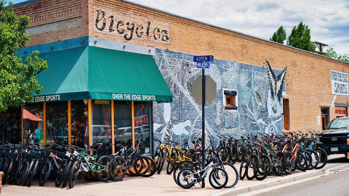 Bicycles lined up outside Over the Edge Sports shop with mural in Fruita, CO.