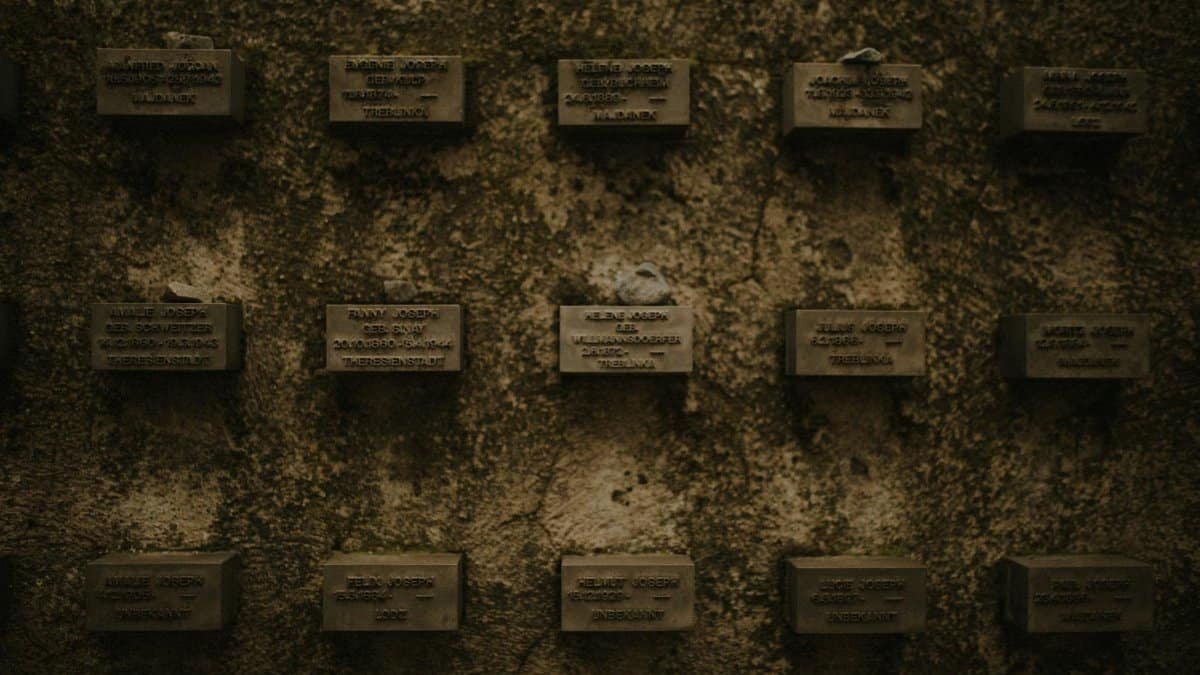 Wall of memorial plaques symbolizing remembrance of historical events.