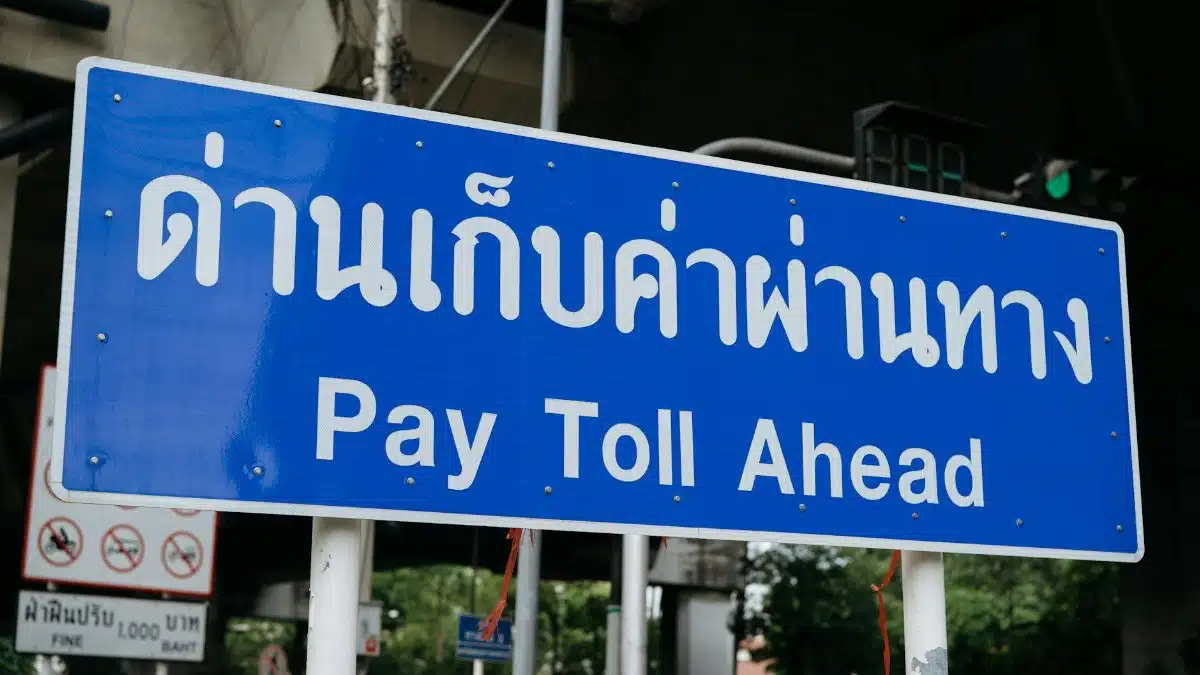 Blue sign indicating a toll road ahead, located in Bangkok, Thailand.