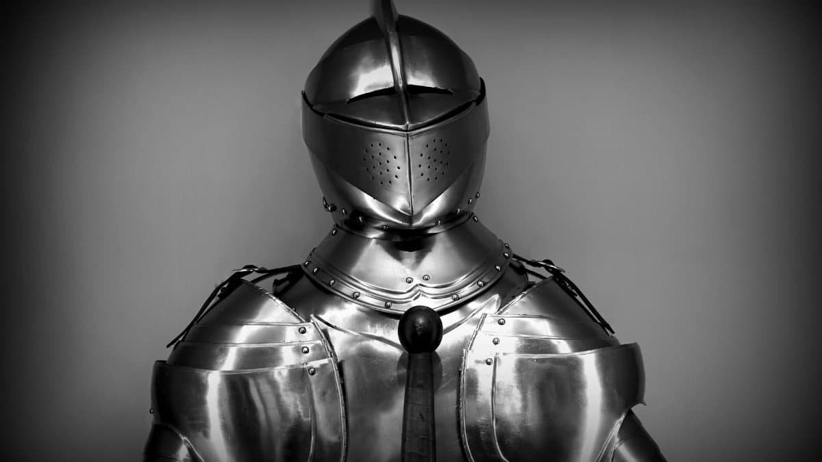 Close-up shot of vintage medieval knight armor in monochrome.