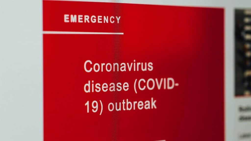 Close-up of a COVID-19 emergency alert message on a digital screen.