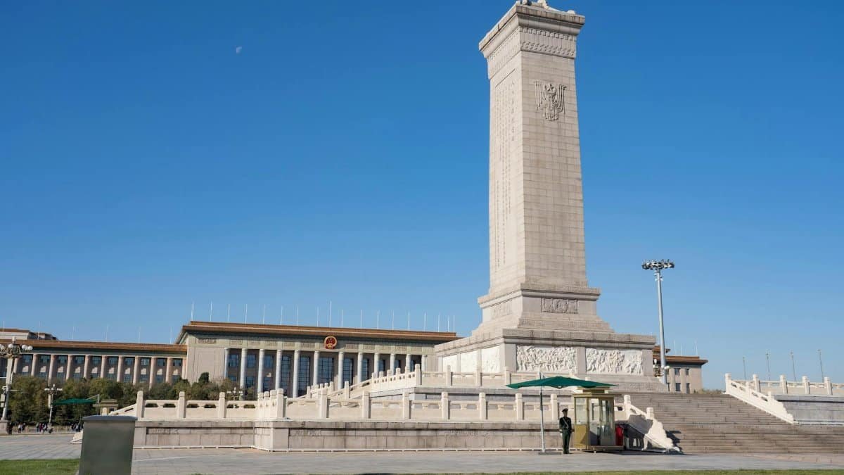 Monument to the People's Heroes in Tiananmen Square, Beijing, China, under a clear blue sky.