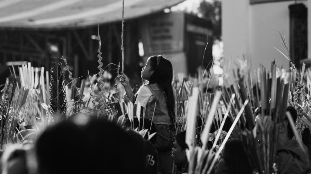 Atmospheric black and white photo capturing a Palm Sunday church gathering in Baguio City.