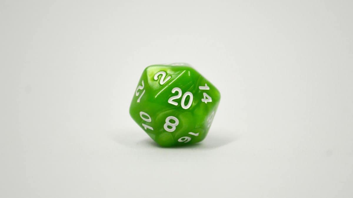 Close-up image of a green 20-sided dice used in tabletop role-playing games.
