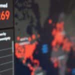 Screen displaying real-time COVID-19 case data with global map and statistics.