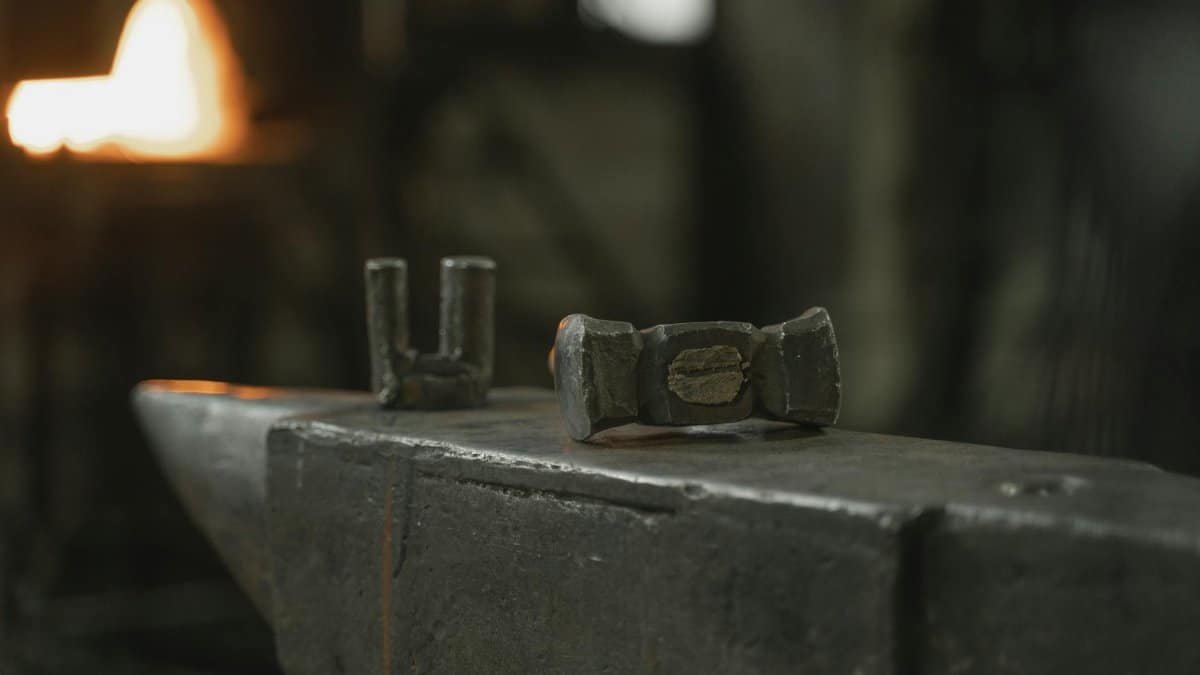 Close-up of an anvil and tools in a blacksmith forge, capturing the essence of metalwork.