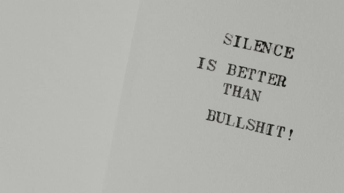Minimalist design featuring the quote 'Silence is better than bullshit' on white paper.