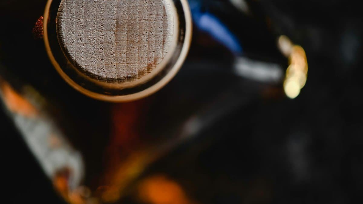 Intricate close-up view of a wooden capped bottle highlighting its texture and details.