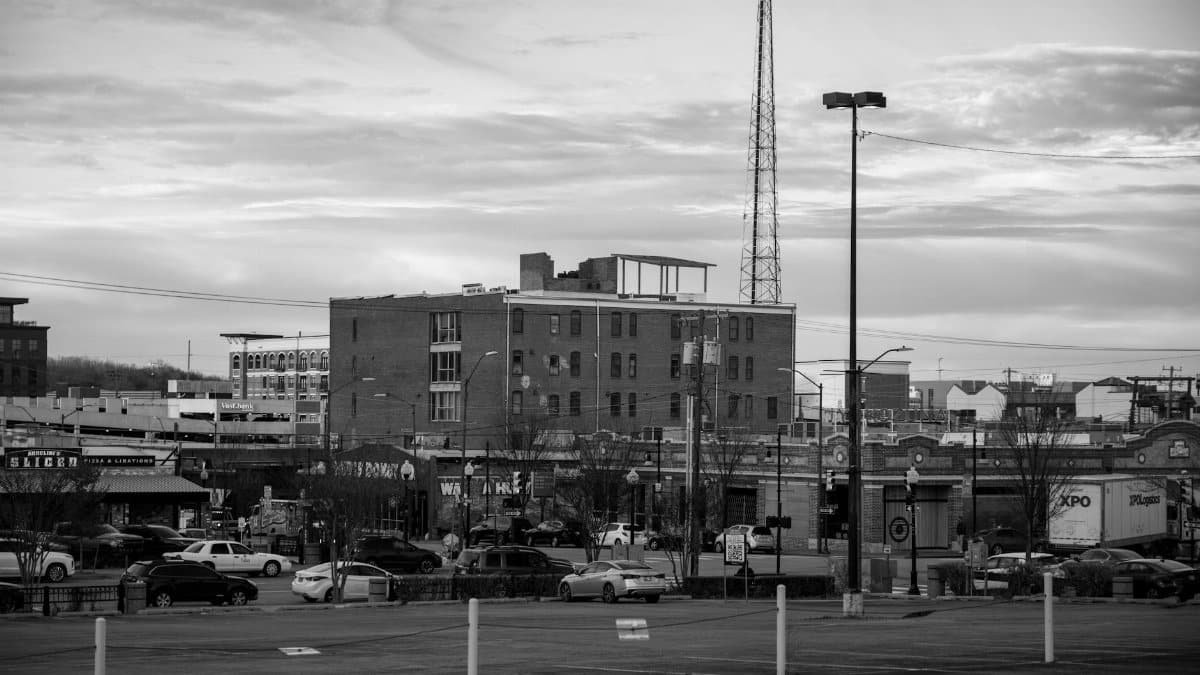 Black and white view of an urban cityscape in Tulsa, Oklahoma featuring buildings and parking lots.