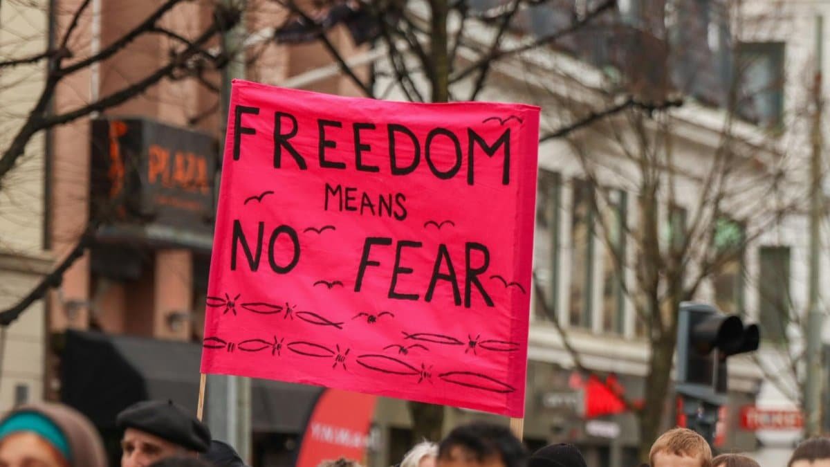 Protesters holding a 'Freedom Means No Fear' sign in Gothenburg, Sweden.