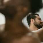 A romantic and intimate moment shared by a shirtless couple in a mirror reflection.