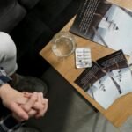 Overhead view of mental health brochures and medication on table in a calming environment.