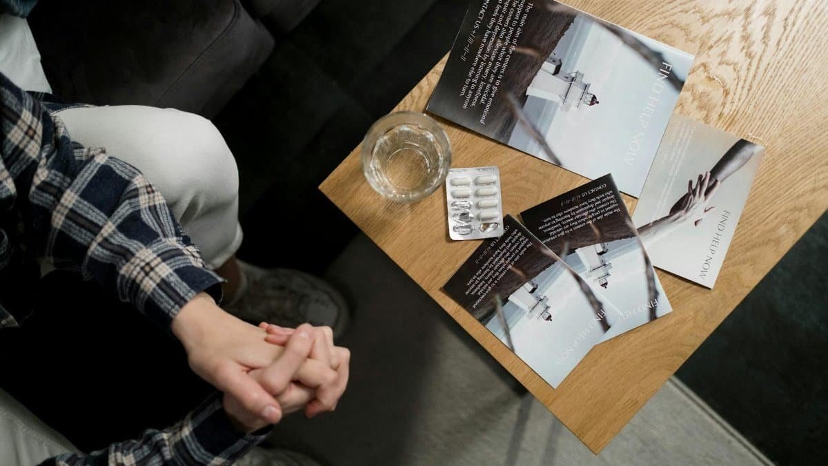 Overhead view of mental health brochures and medication on table in a calming environment.