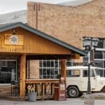 Explore a vintage cafe experience along Route 66 in Williams, Arizona featuring classic decor and a retro vehicle.