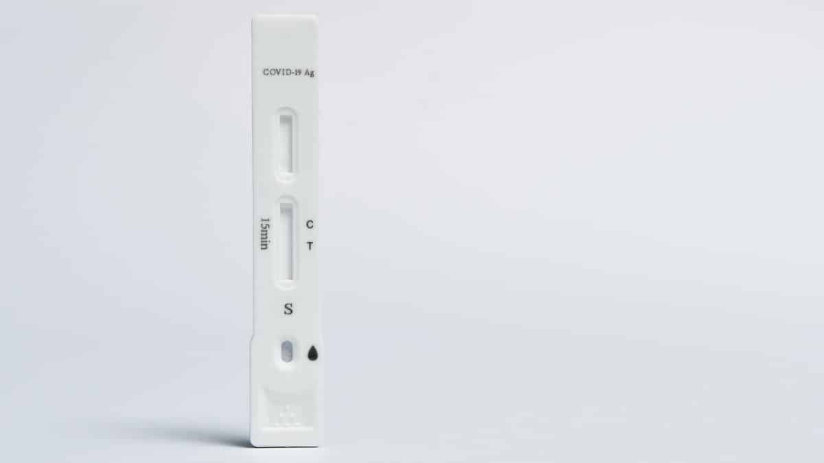 Isolated COVID-19 rapid antigen test on a white background, showing test and control lines.