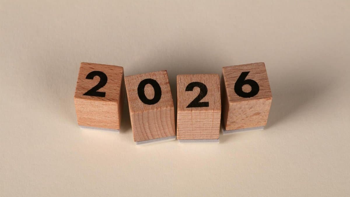 Wooden cubes forming the year 2026 on a neutral background.