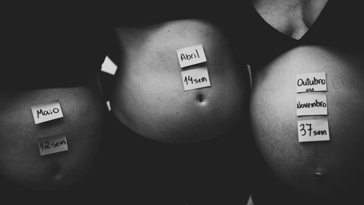 Three pregnant bellies labeled with months and weeks in grayscale setting.
