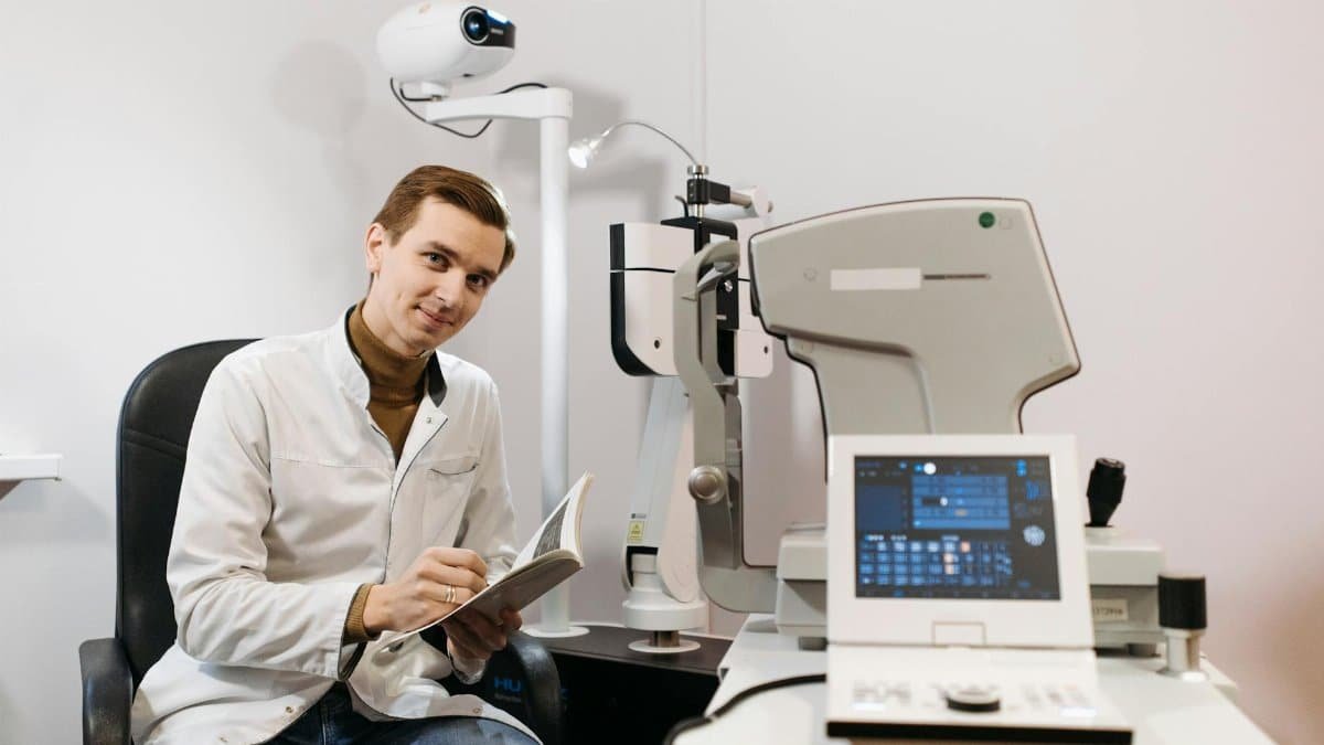A professional ophthalmologist preparing for an eye examination in a modern clinic with advanced equipment.