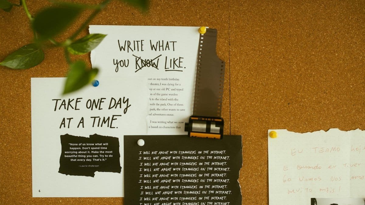 A corkboard with motivational quotes, notes, and film negatives, fostering creativity and reflection.
