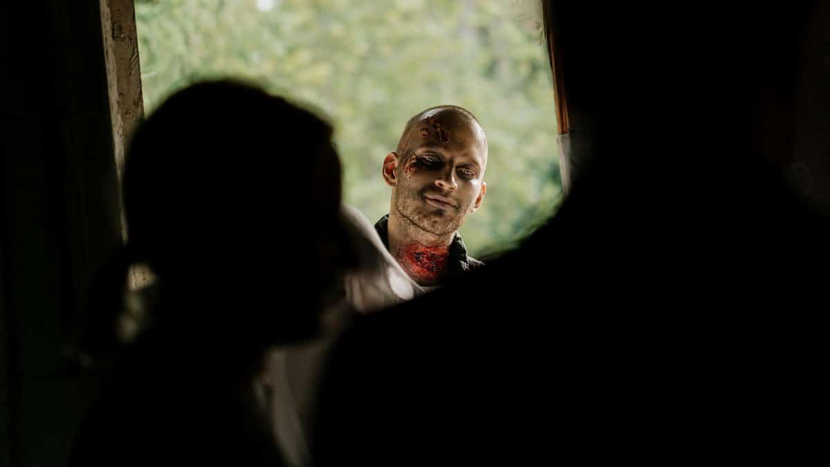 A chilling scene with a zombie peering through a doorway, perfect for horror themes.