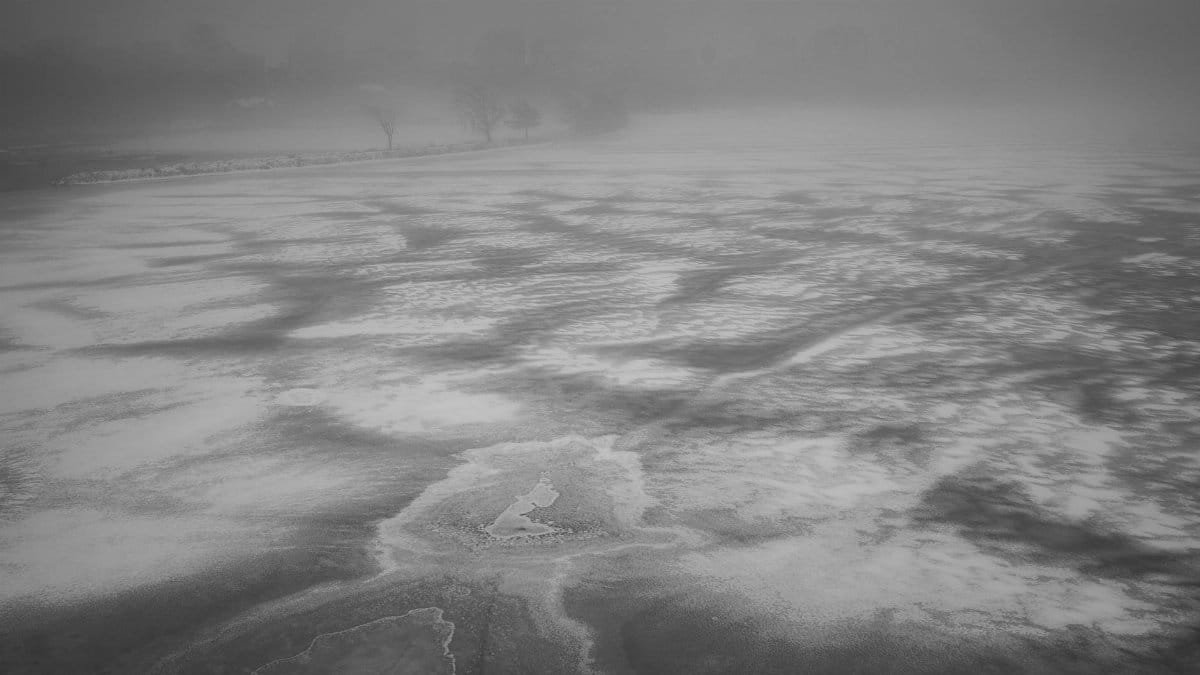 Foggy Boston landscape showcasing a vast icy surface in winter.