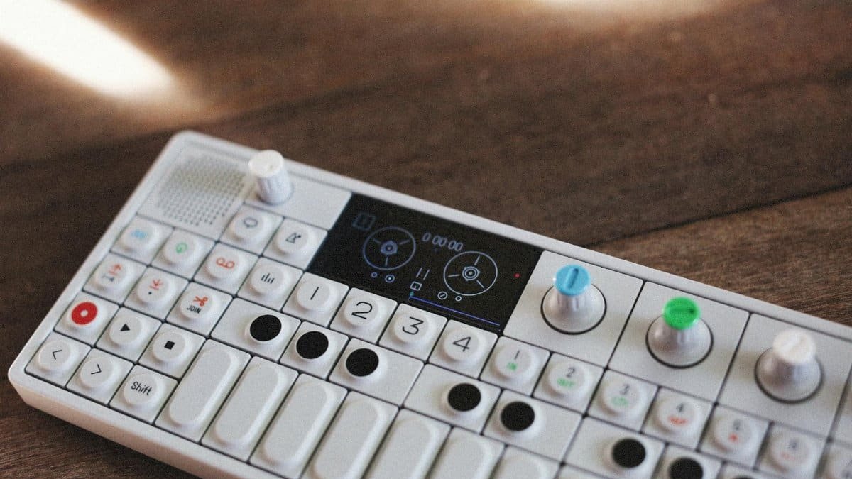 Portable white music synthesizer with colorful knobs, perfect for digital sound mixing.