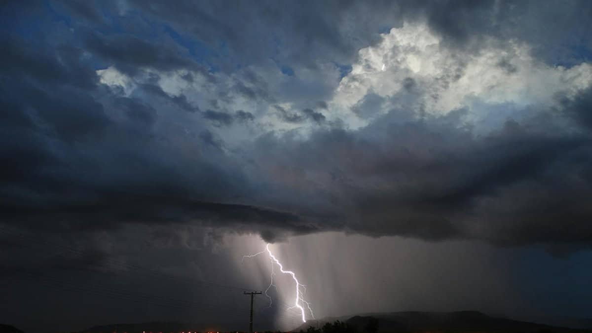 Captivating night scene of a thunderstorm with lightning over a cityscape, highlighting dramatic skies.