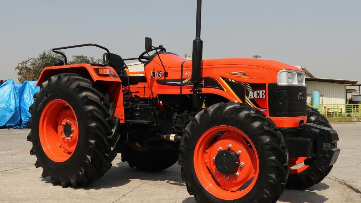 A bright orange ACE DI 65 4WD tractor showcased outdoors in Faridabad, India.