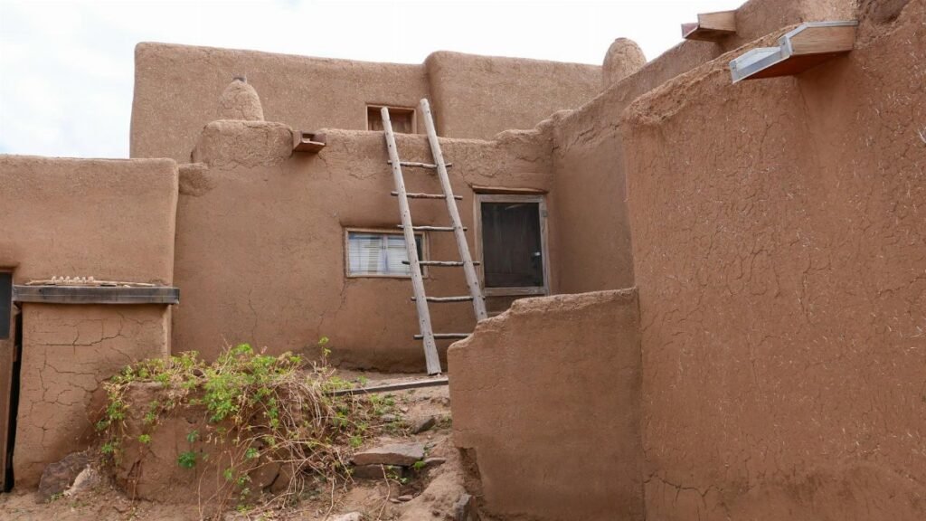 Traditional adobe architecture in Taos Pueblo, New Mexico showcasing rustic charm.