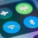 A close-up image showing smartphone control panel with various icons like WiFi and Bluetooth.