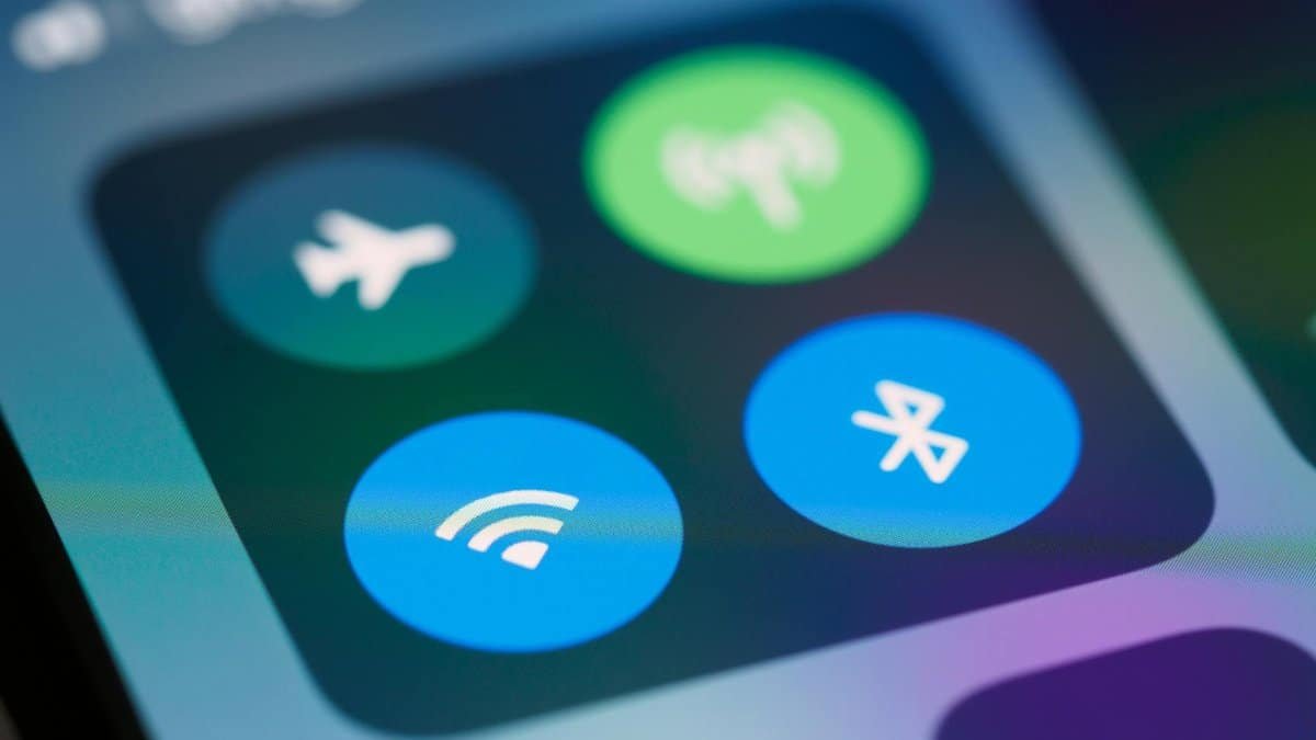 A close-up image showing smartphone control panel with various icons like WiFi and Bluetooth.