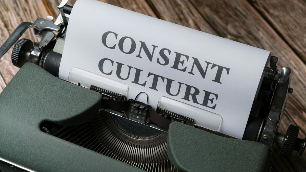 Close-up of a typewriter with paper showing 'Consent Culture' in a vintage aesthetic.