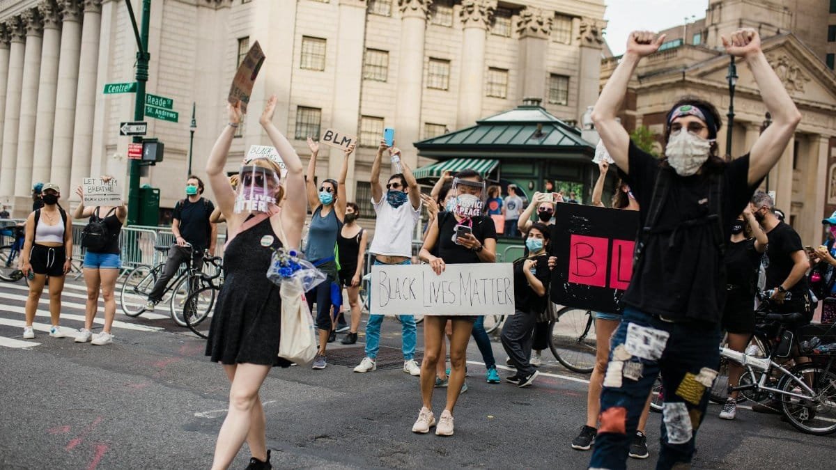 Protesters gather in the city for racial justice holding Black Lives Matter signs.