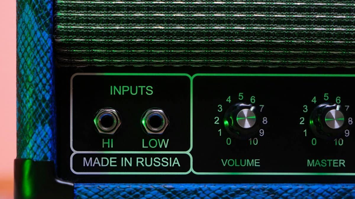 Close-up of a high-quality guitar amplifier with inputs and volume knobs, made in Russia.