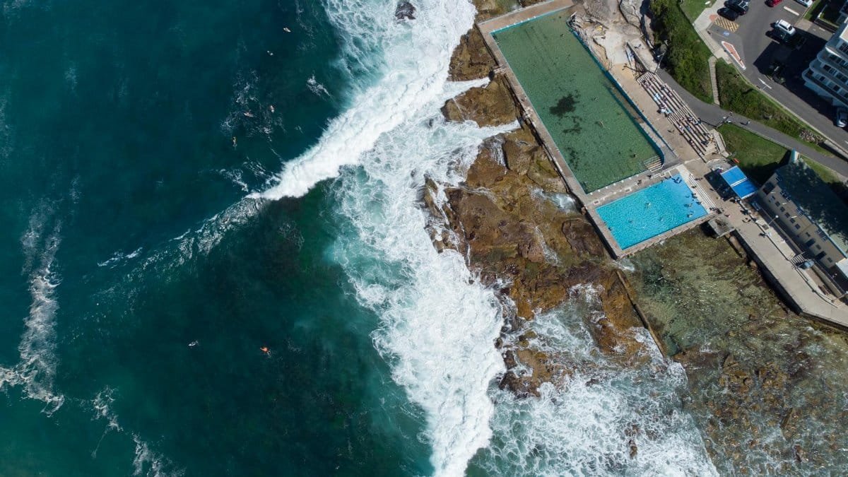 Stunning aerial view of Dee Why rock pools and crashing ocean waves, NSW, Australia.