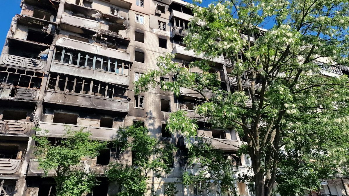 A damaged residential building in Irpin, Ukraine, showcasing its war-torn condition.