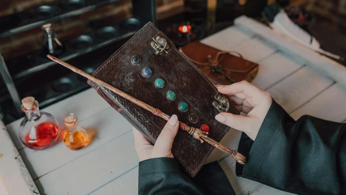 A person holding a magical spell book and wand, perfect for fantasy themes.