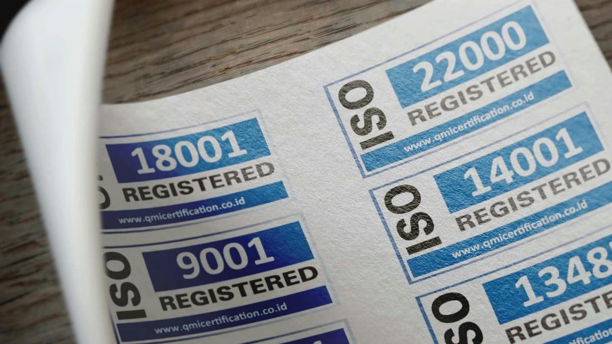 ISO certification stickers with registration numbers on paper.