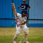 A young cricketer prepares to bat during a match in Gahunje, India.