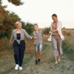 Multi-generational family enjoying a joyful walk outdoors during the summer.