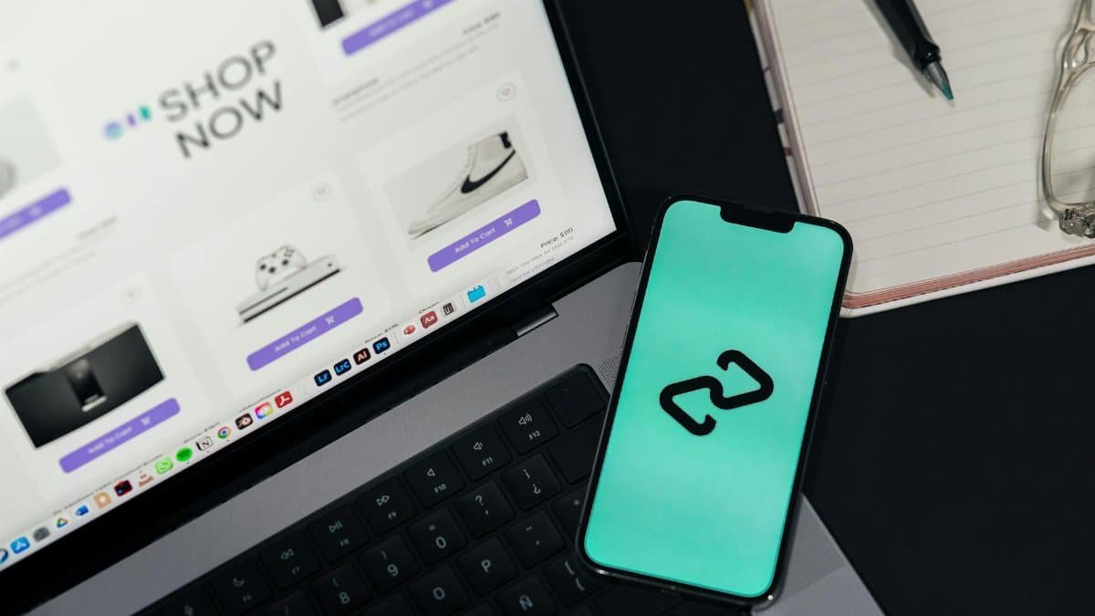 A smartphone and laptop displaying online shopping platforms, suggesting digital retail.