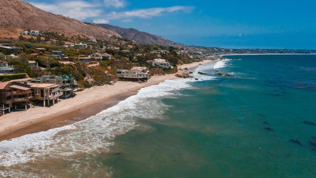 A breathtaking aerial view of Malibu's beachfront homes along the scenic coastline.