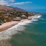 A breathtaking aerial view of Malibu's beachfront homes along the scenic coastline.