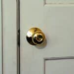 White door featuring a shiny brass knob, ideal for home interior design themes.
