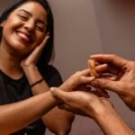 A joyful woman receives an onion ring in a playful marriage proposal.