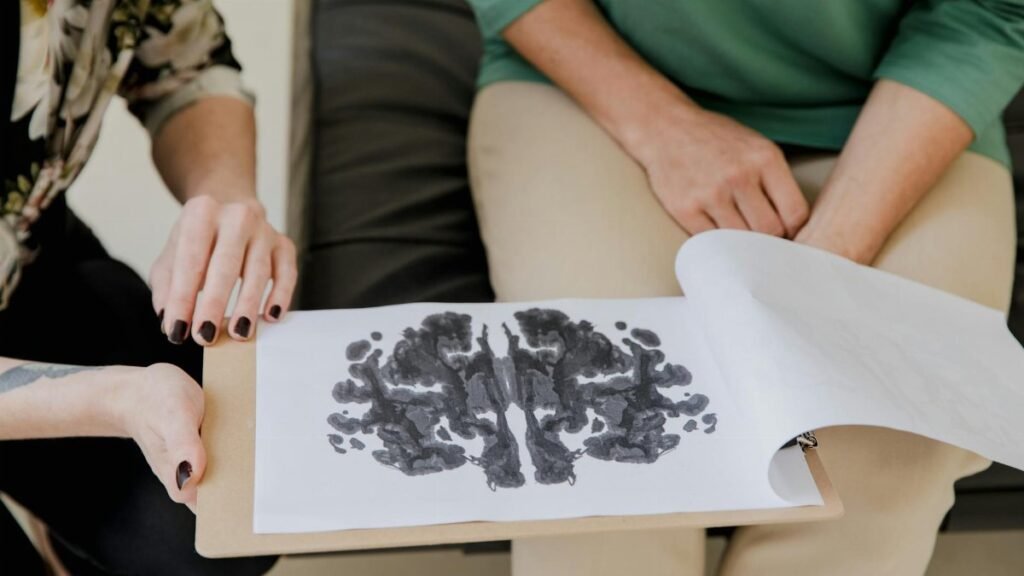A close-up of a Rorschach inkblot test during a psychotherapy session, highlighting mental health care.