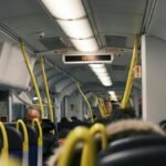 Passengers commuting inside a modern public train during the day.