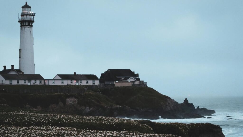 A scenic view of Pigeon Point Lighthouse and seashore in Pescadero, California.